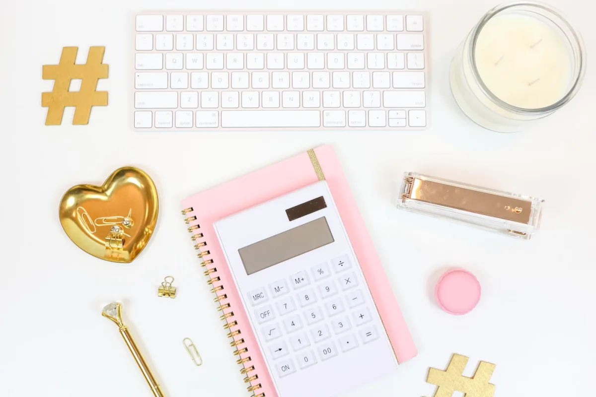 Calculator and notebook on a blush desk — the audit stage