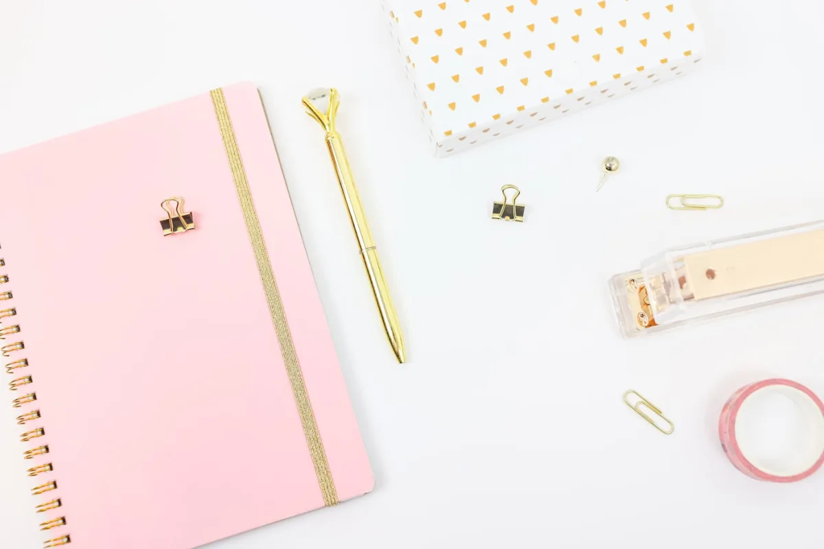 Pink notebook and gold pen — the one-page plan